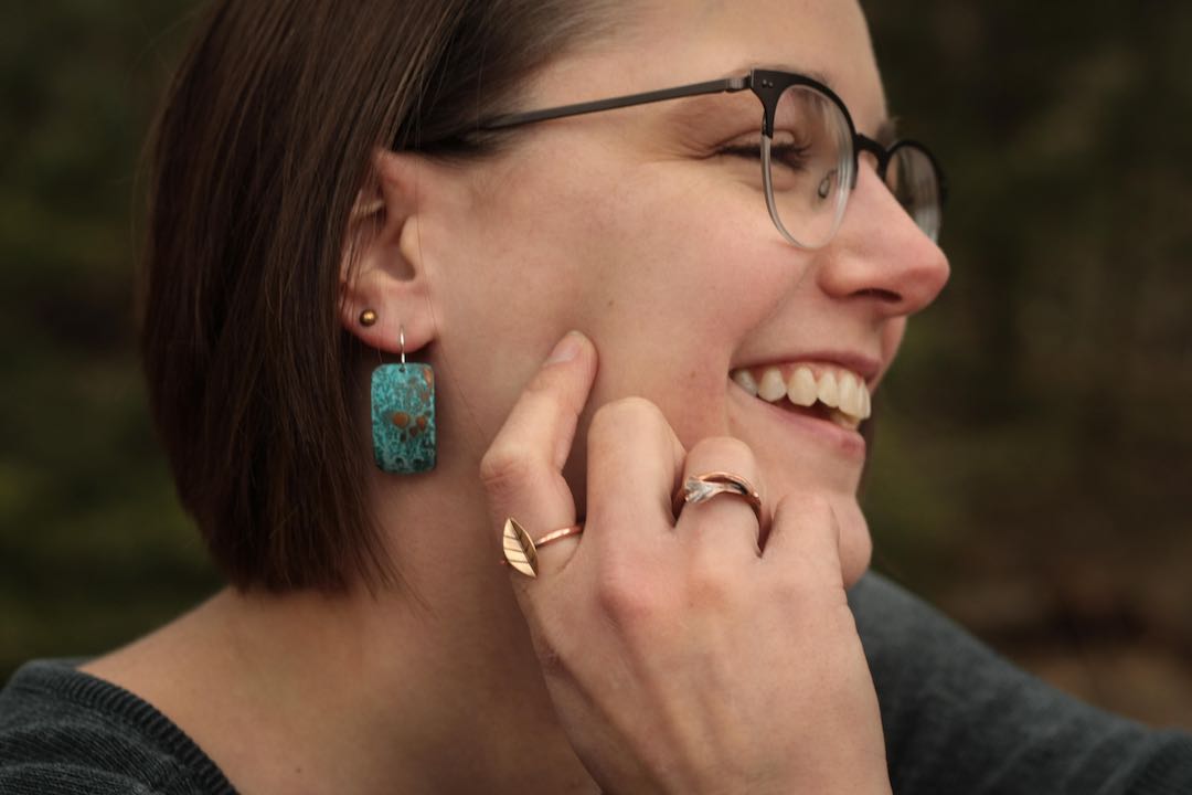 Blue Patina Earrings and two rings on artist