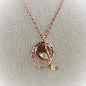 round red cabochon pendant set in copper with twisting vine
