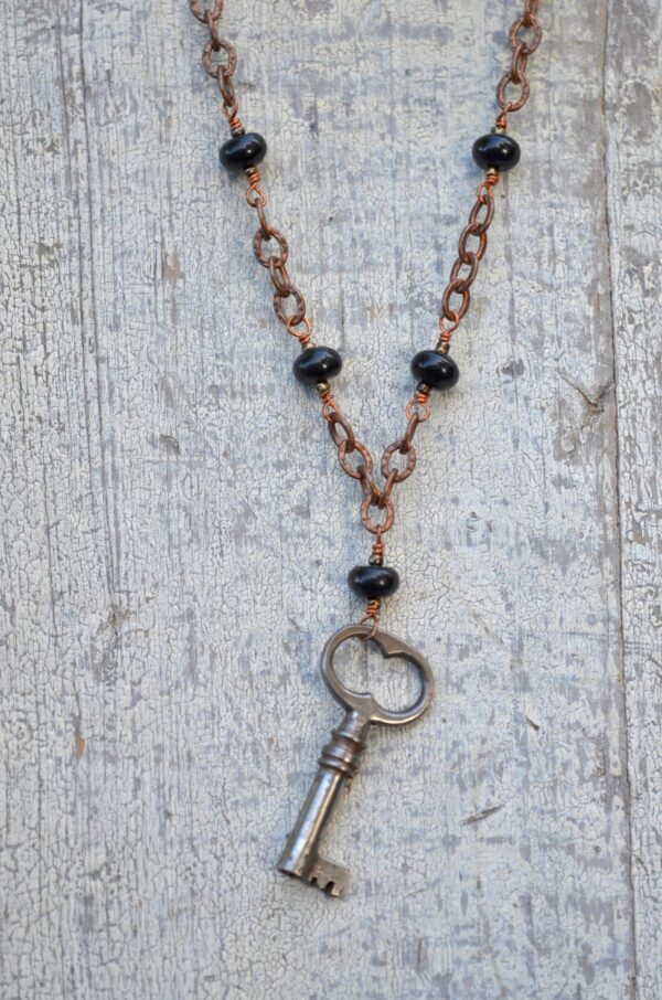 antique key necklace with copper chain and brown gemstones