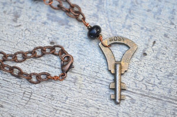 antique key necklace with copper chain and brown gemstones clasp