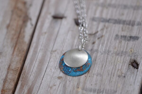 blue patina dome necklace with brushed nickel overlay necklace horizontal image on wood