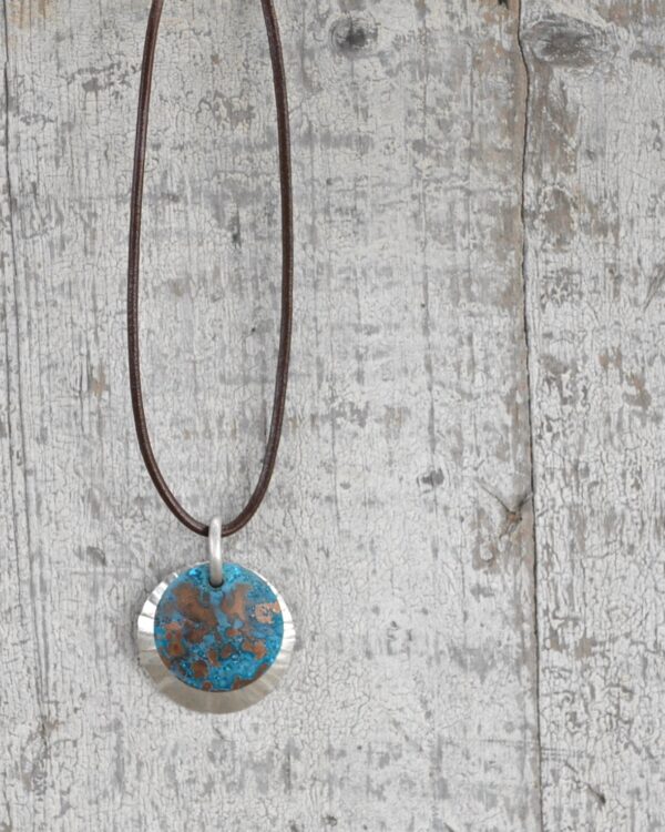 blue patina overlay on textured brushed nickel dome leath necklace vertical image on white